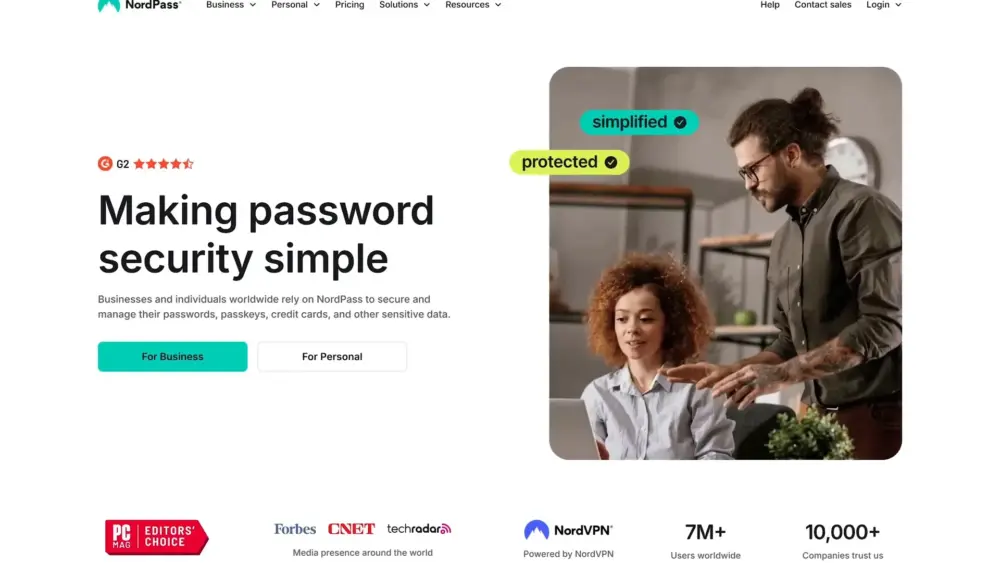 Two people are sitting at a desk, and one of them is pointing at a laptop screen. Big words on the page say Making password security simple. At the top, there is NordPass’s logo and menu options.
